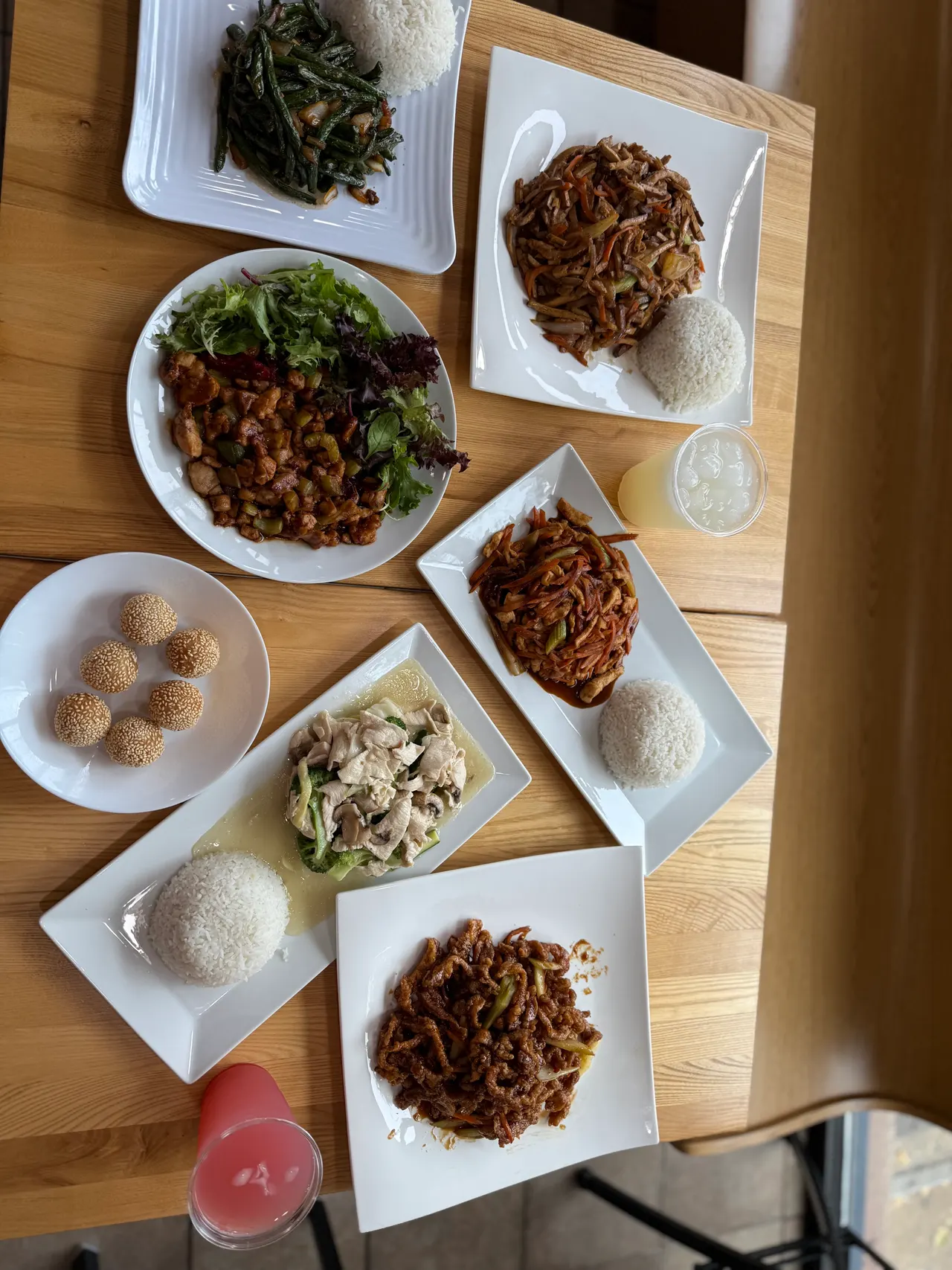 A table of Oriental Cafe dishes: Kung Pao salad, string beans, shredded beef, moo goo chicken and sesame balls