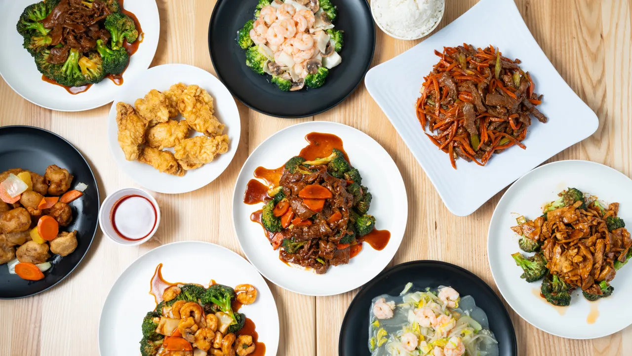 A spread of Oriental Cafe dishes on a wooden table